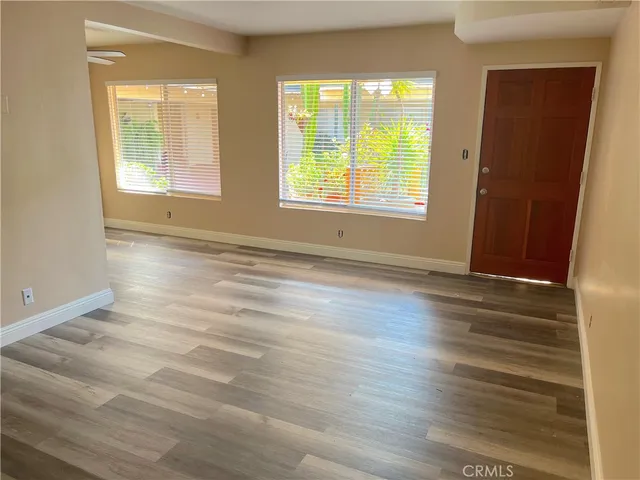 wooden floor in an empty room with a window