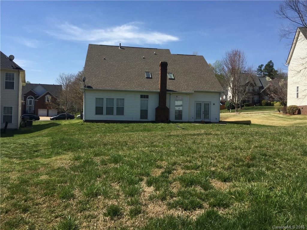 12232 Old Timber Road Charlotte, NC 28269 - Photo 2 of 15 a view of a house next to a big yard