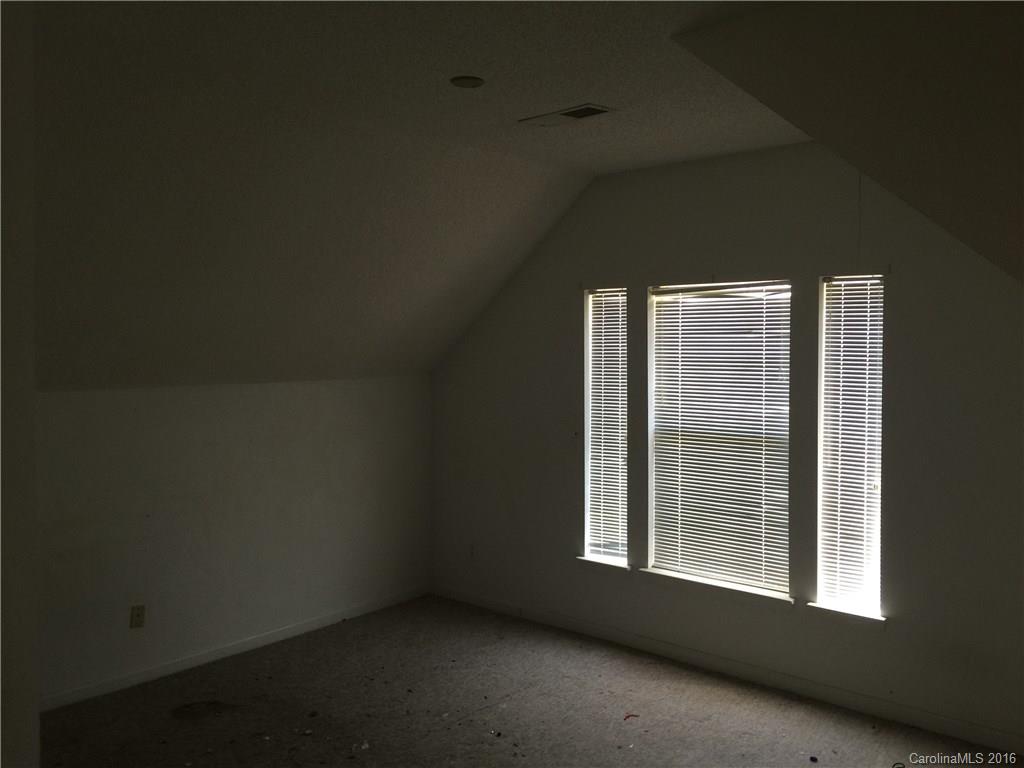 12232 Old Timber Road Charlotte, NC 28269 - Photo 12 of 15 a view of an empty room with a window
