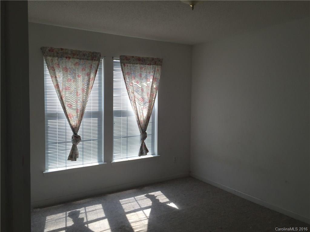 12232 Old Timber Road Charlotte, NC 28269 - Photo 14 of 15 an empty room with windows