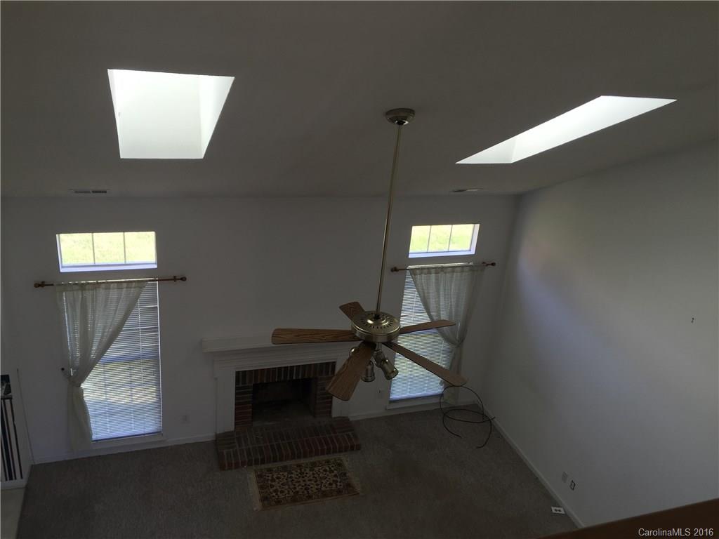 12232 Old Timber Road Charlotte, NC 28269 - Photo 4 of 15 a view of an empty room and window