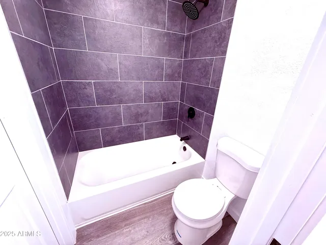 a bathroom with a sink a toilet a mirror and shower