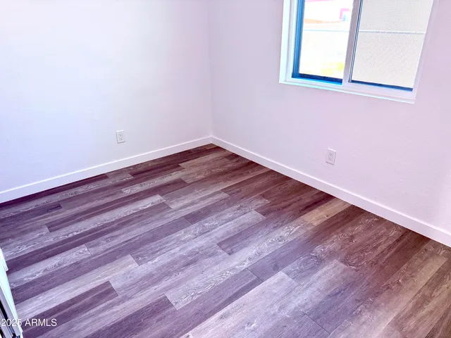 a view of a room with wooden floor