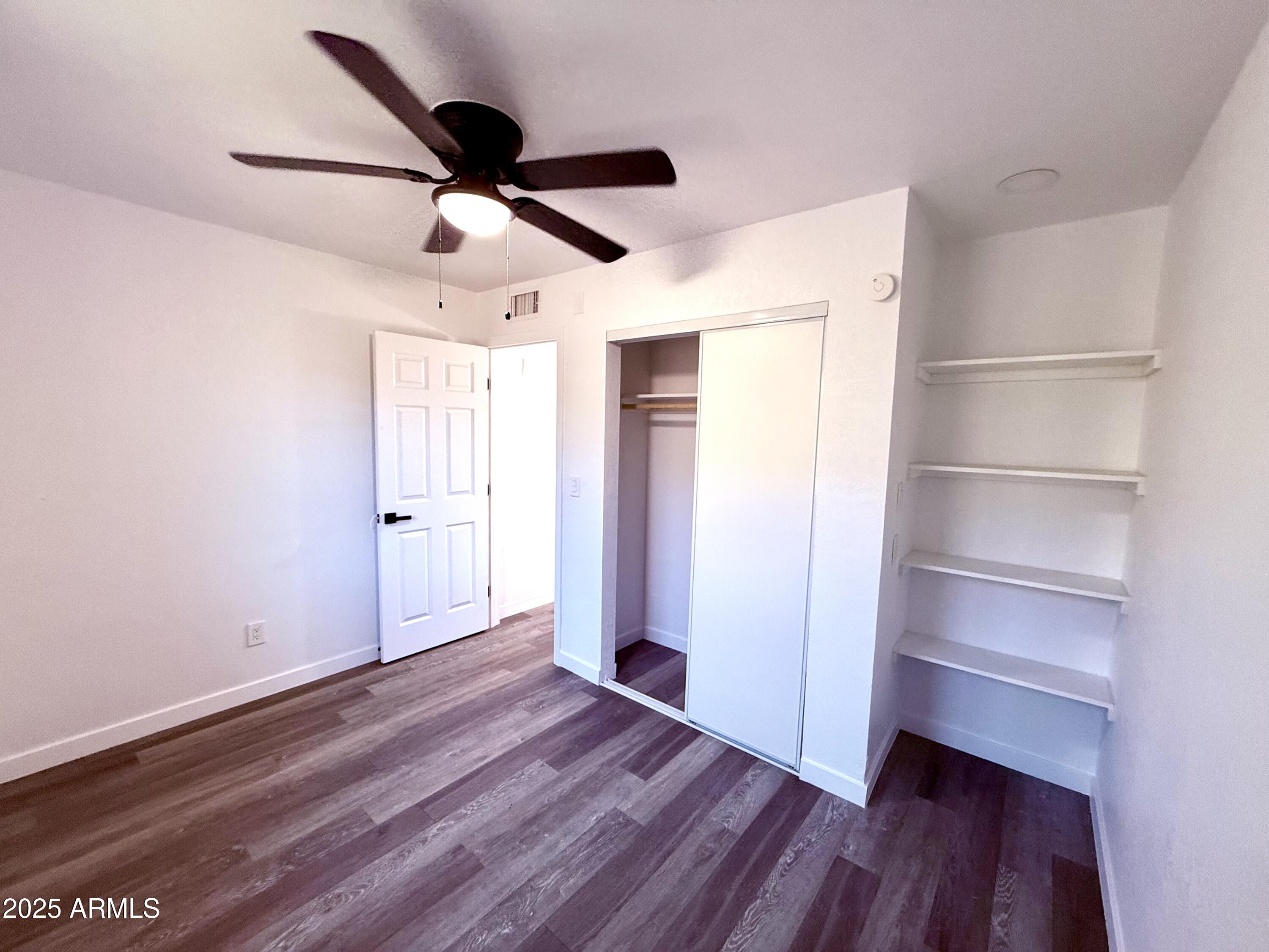 1009 East Chipman Road Phoenix, AZ 85040 - Photo 26 of 30 a view of empty room with wooden floor and window