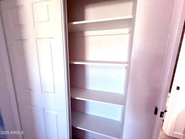 a view of a storage and utility room with a sink