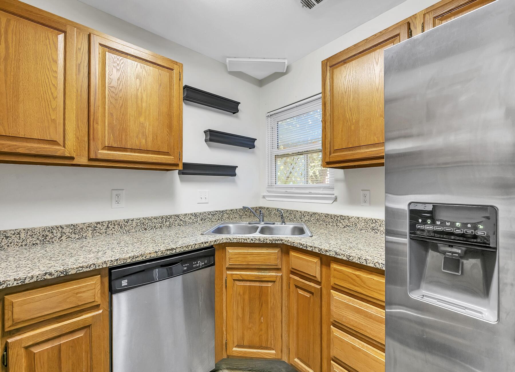 16 Gardner Drive Shalimar, FL 32579 - Photo 13 of 45 a kitchen with granite countertop cabinets stainless steel appliances a sink and a window