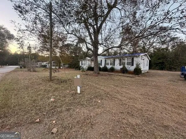 a view of a yard with a house and trees