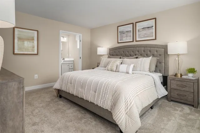 a bedroom with bed and night stand