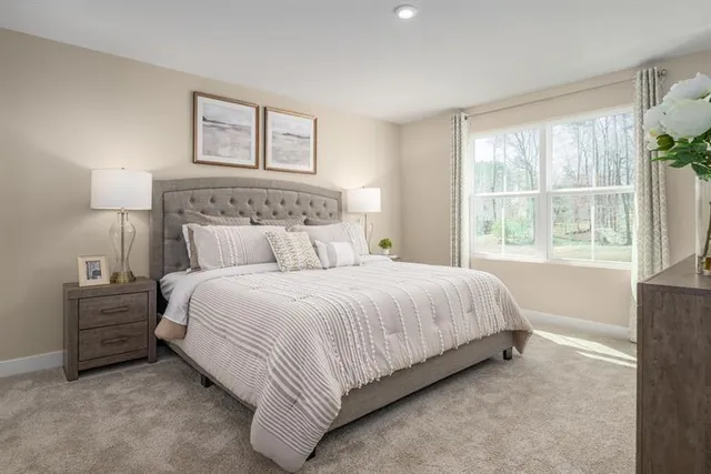 a bedroom with a bed and a night stand