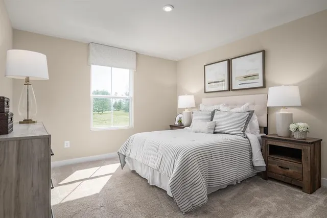 a bedroom with a bed and a lamp