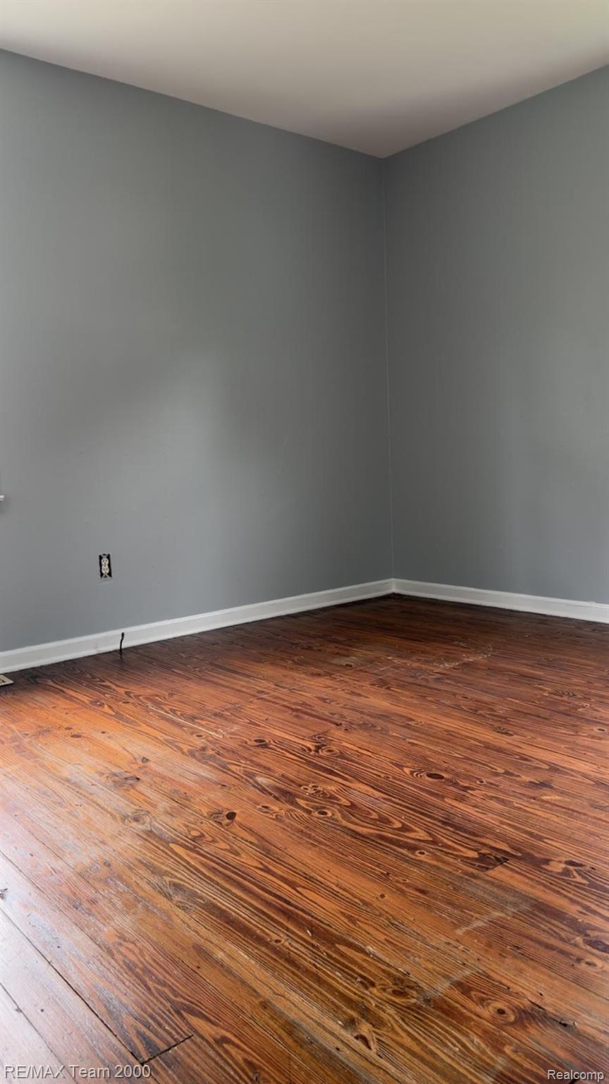 6646 Harding Street Taylor, MI 48180 - Photo 5 of 12 Wood-finish flooring with a natural grain, complemented by neutral gray walls and white baseboards
