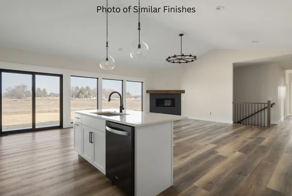 a kitchen with cabinets appliances and a sink