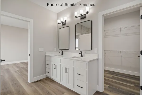 a bathroom with a double vanity sink mirror and toilet