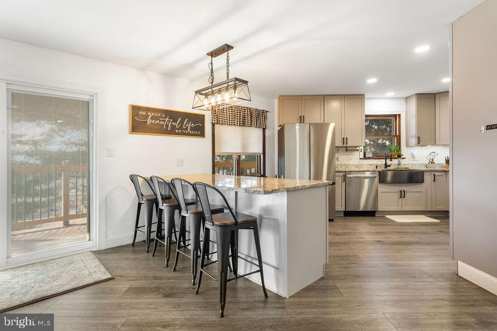 2276 Ridge Road York, PA 17406 - Photo 7 of 34 a view of a dining room and livingroom with furniture wooden floor a chandelier