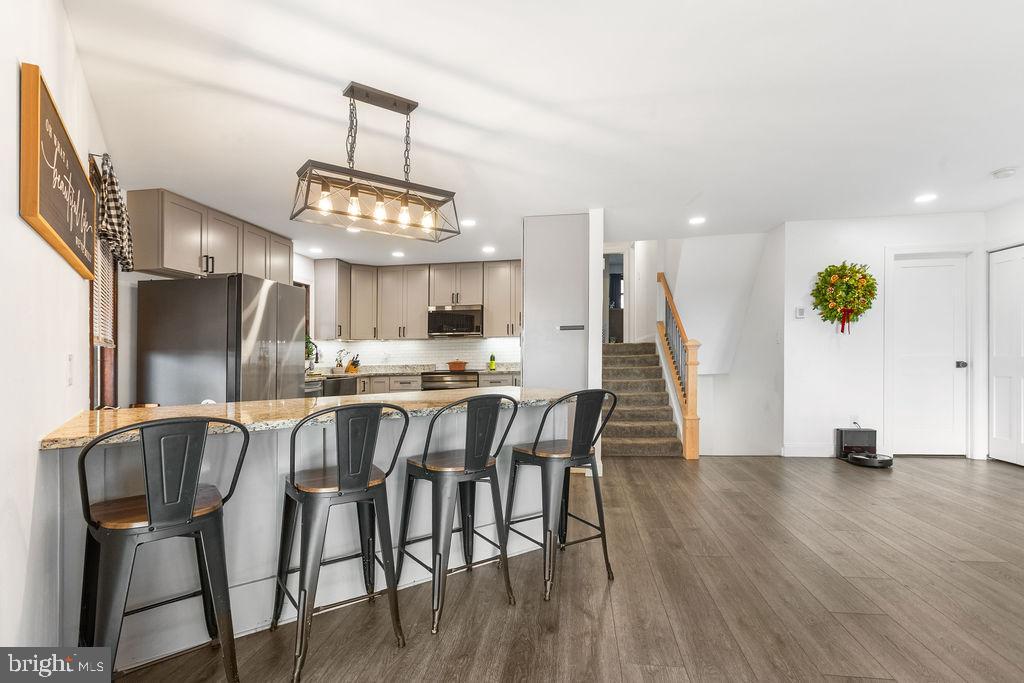 2276 Ridge Road York, PA 17406 - Photo 8 of 34 a dining room with wooden floor a chandelier a glass table and chairs