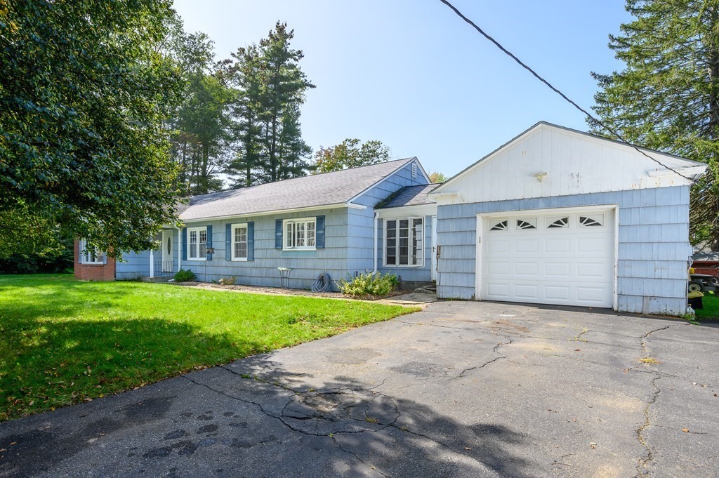 627 Pleasant Street Athol, MA 01331 - Photo 14 of 16 a view of a yard in front of a house with plants and large tree