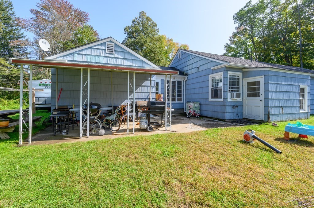 627 Pleasant Street Athol, MA 01331 - Photo 16 of 16 a view of a house with a patio and a garden