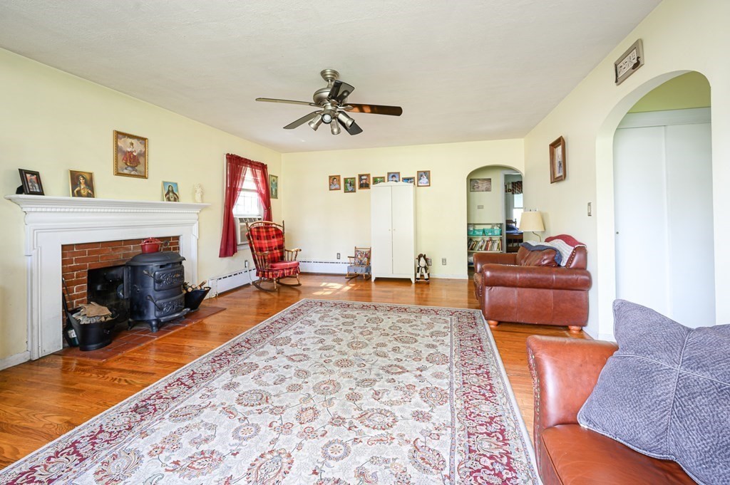 627 Pleasant Street Athol, MA 01331 - Photo 2 of 16 a living room with furniture and a fireplace