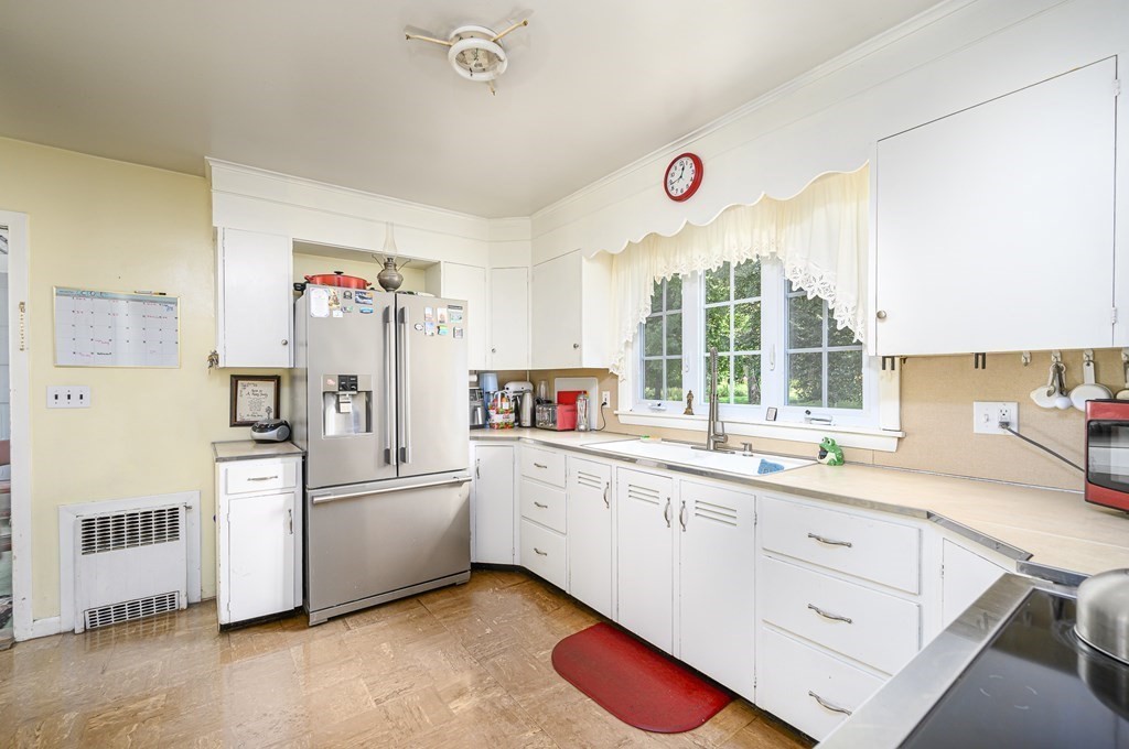 627 Pleasant Street Athol, MA 01331 - Photo 6 of 16 a kitchen with a sink and white cabinets