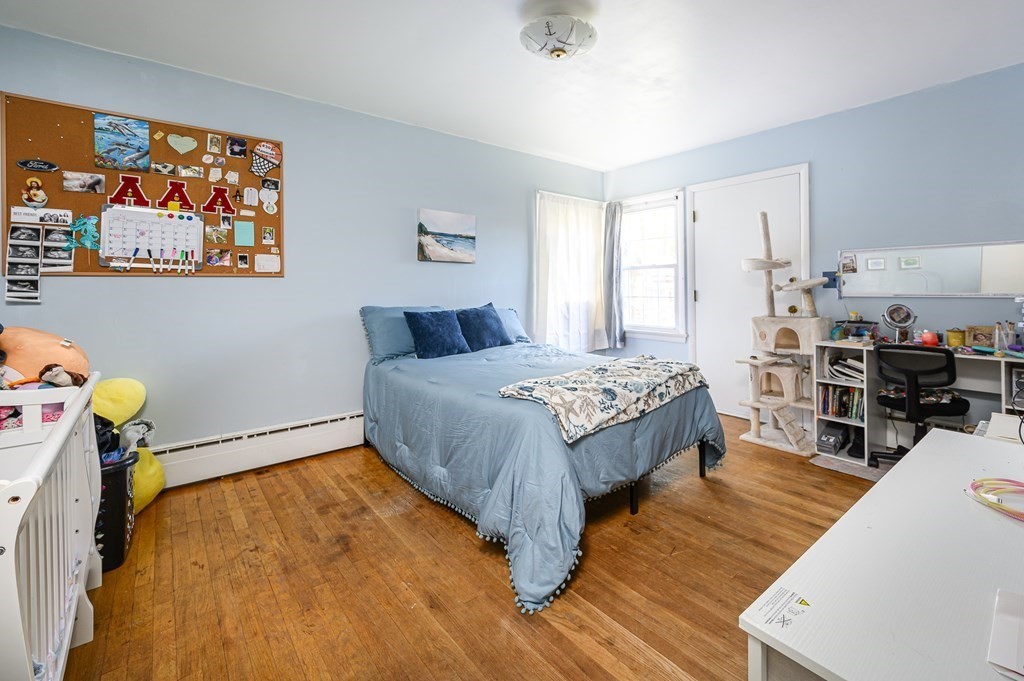 627 Pleasant Street Athol, MA 01331 - Photo 9 of 16 a bedroom with a bed and wooden floor