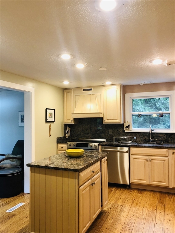 99 Lacy Road Jaffrey, NH 03452 - Photo 5 of 29 a kitchen with stainless steel appliances granite countertop a stove a sink and a microwave