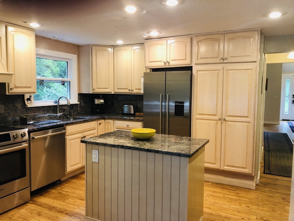 99 Lacy Road Jaffrey, NH 03452 - Photo 6 of 29 a kitchen with stainless steel appliances granite countertop a sink a refrigerator and a granite counter tops