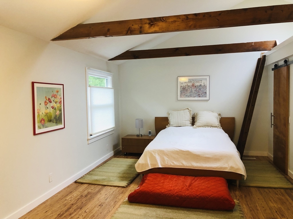 99 Lacy Road Jaffrey, NH 03452 - Photo 10 of 29 a bedroom with a bed and wooden floor