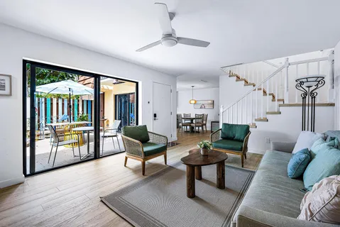 a living room with furniture and a wooden floor