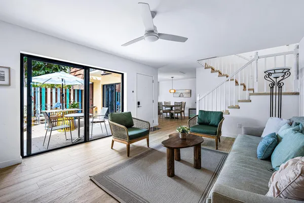 a living room with furniture and a wooden floor