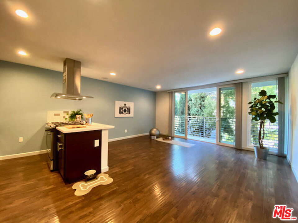 a view of a room with wooden floor and a window