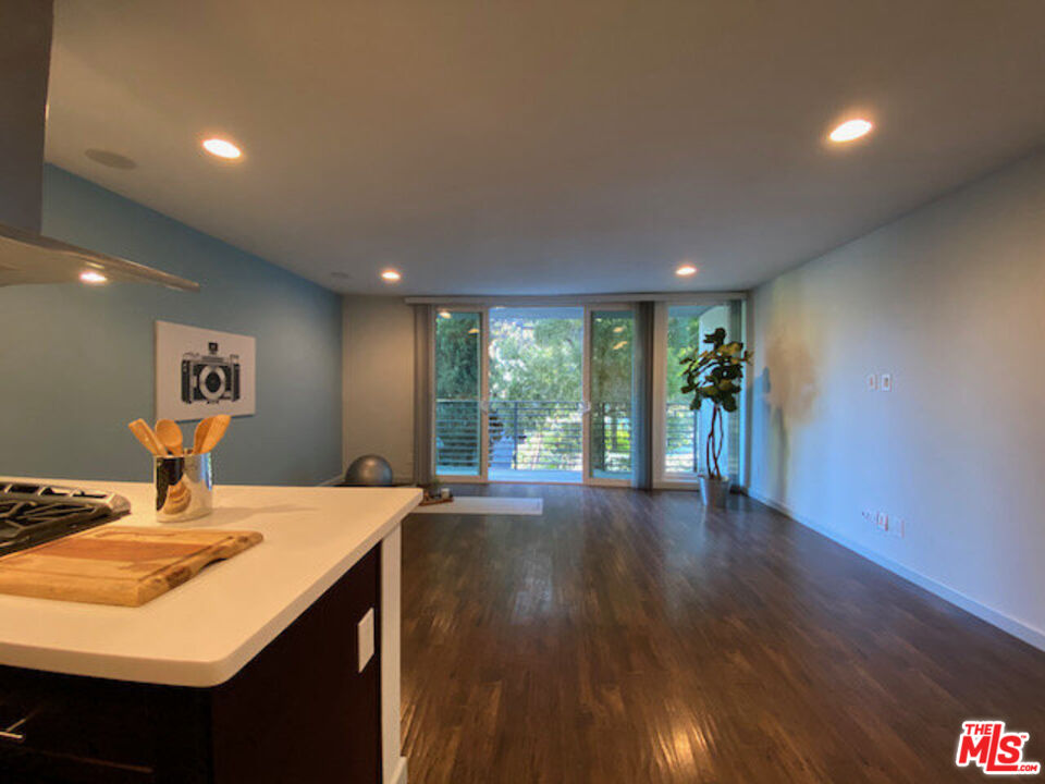 1920 Hillcrest Road, Unit 5 Los Angeles, CA 90068 - Photo 15 of 17 a view of a room with gym equipment and wooden floor
