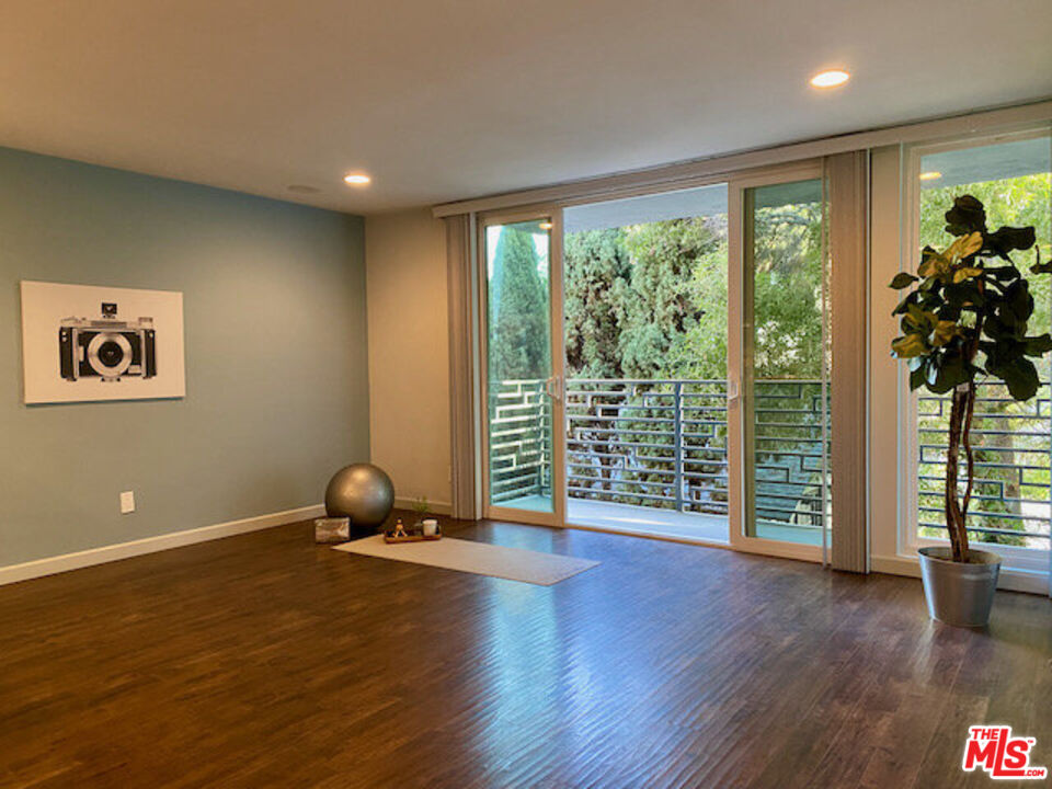 1920 Hillcrest Road, Unit 5 Los Angeles, CA 90068 - Photo 2 of 17 a view of room with floor to ceiling window and wooden floor
