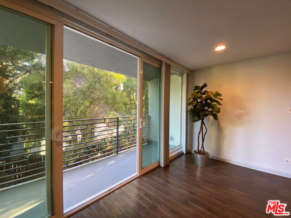 1920 Hillcrest Road, Unit 5 Los Angeles, CA 90068 - Photo 3 of 17 a view of a room with wooden floor and potted plants