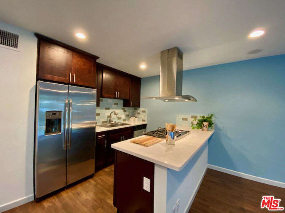 1920 Hillcrest Road, Unit 5 Los Angeles, CA 90068 - Photo 6 of 17 a kitchen with stainless steel appliances a sink stove and refrigerator