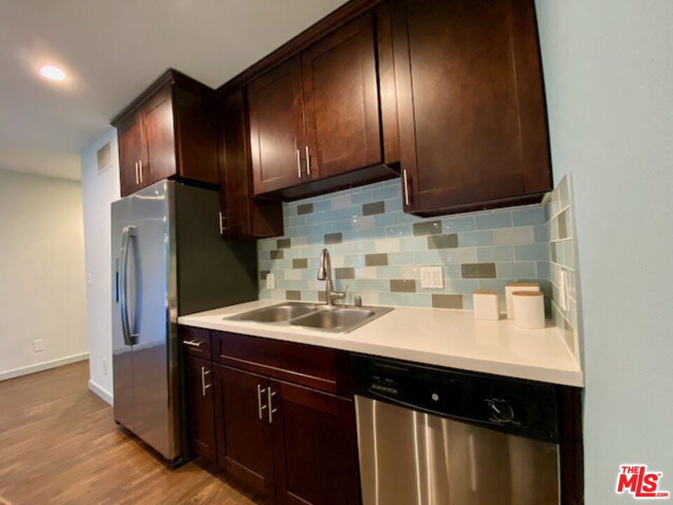 1920 Hillcrest Road, Unit 5 Los Angeles, CA 90068 - Photo 7 of 17 a kitchen with a sink cabinets and stainless steel appliances