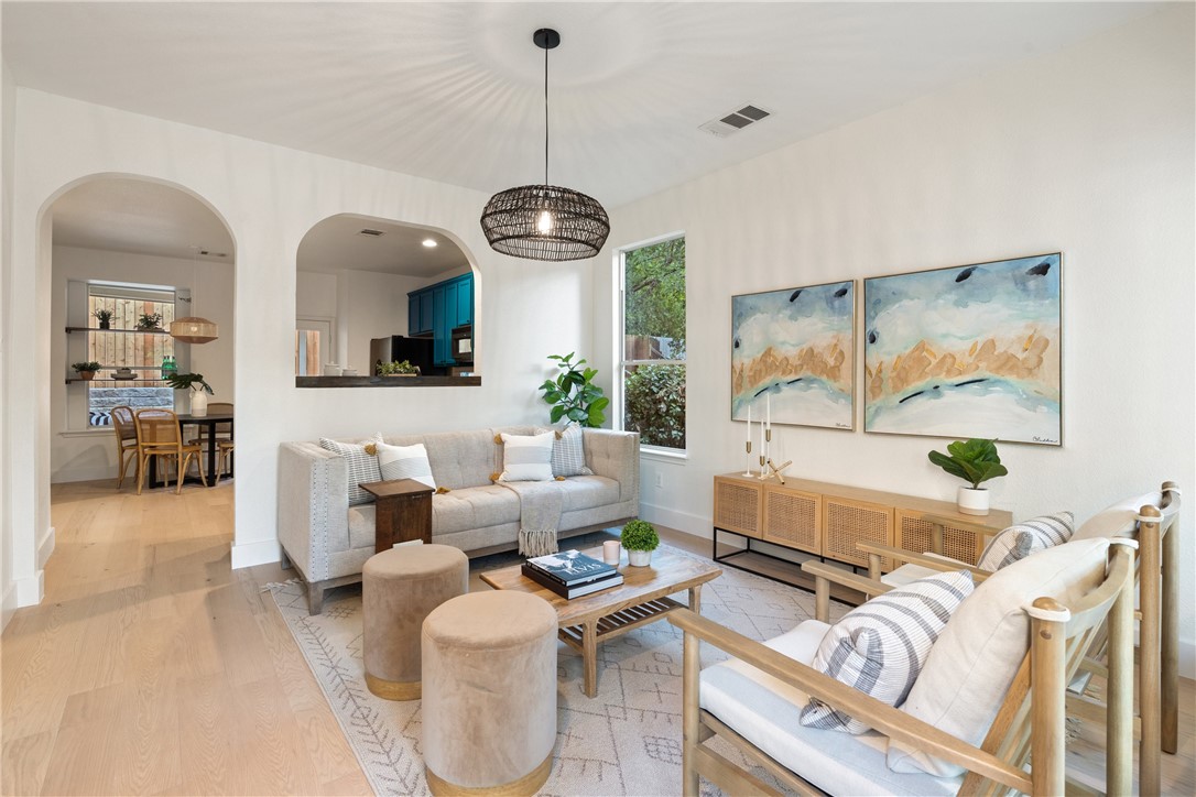 a living room with furniture a window and a chandelier