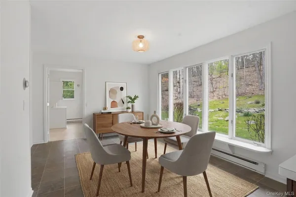 a dining room with furniture a rug and a large window