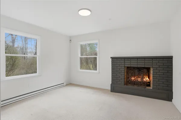 an empty room with a fireplace and window