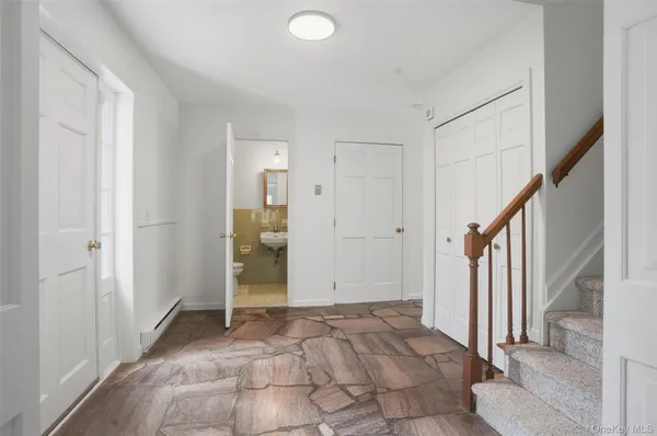 a view of entryway with wooden floor and stairs