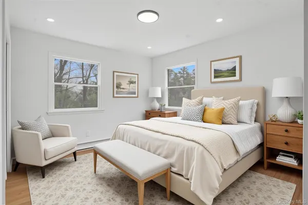 a spacious bedroom with a bed and a couch