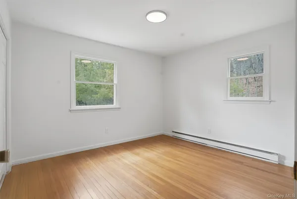 wooden floor in an empty room with a window
