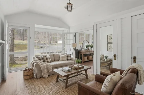 a living room with furniture a fireplace and a table