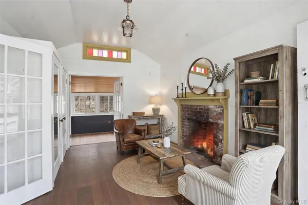 a living room with furniture a chandelier and a fireplace