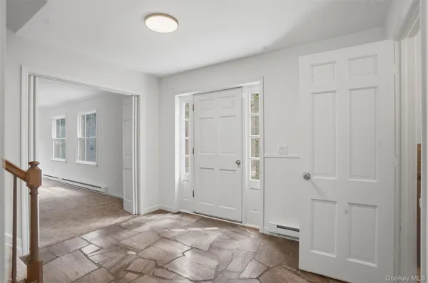 an empty room with windows and closet area