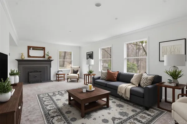 a living room with furniture a fireplace and a table