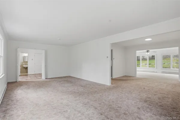 an empty room with windows and bathroom