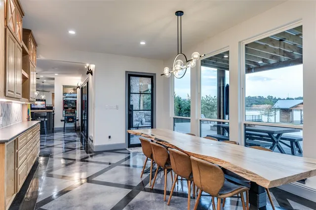 a dining room with furniture a chandelier and wooden floor