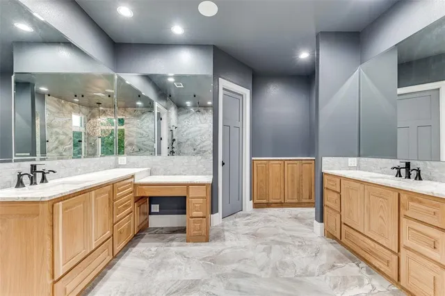 a large bathroom with double vanity and a tub