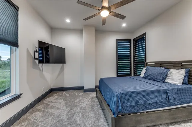 a bedroom with a large bed and a flat screen tv