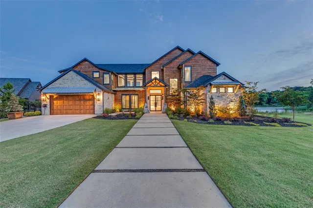a front view of a house with a yard and garden
